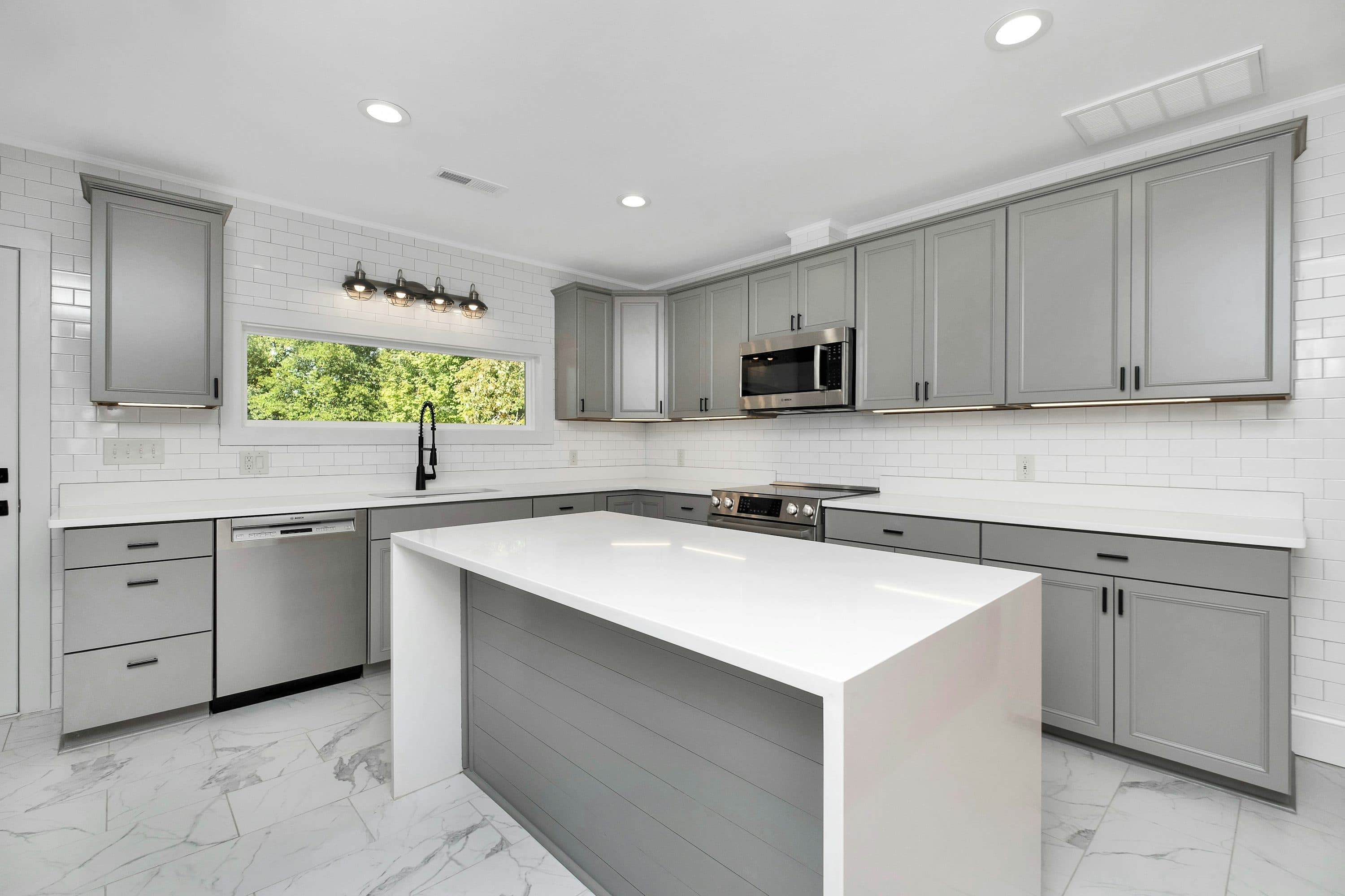 White kitchen with center island and top cabinets